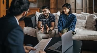 Couple talking with real estate agent